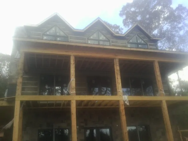 Dormers and porch framing on a large log home under construction — Roof Coating work by our crew in Issaquah