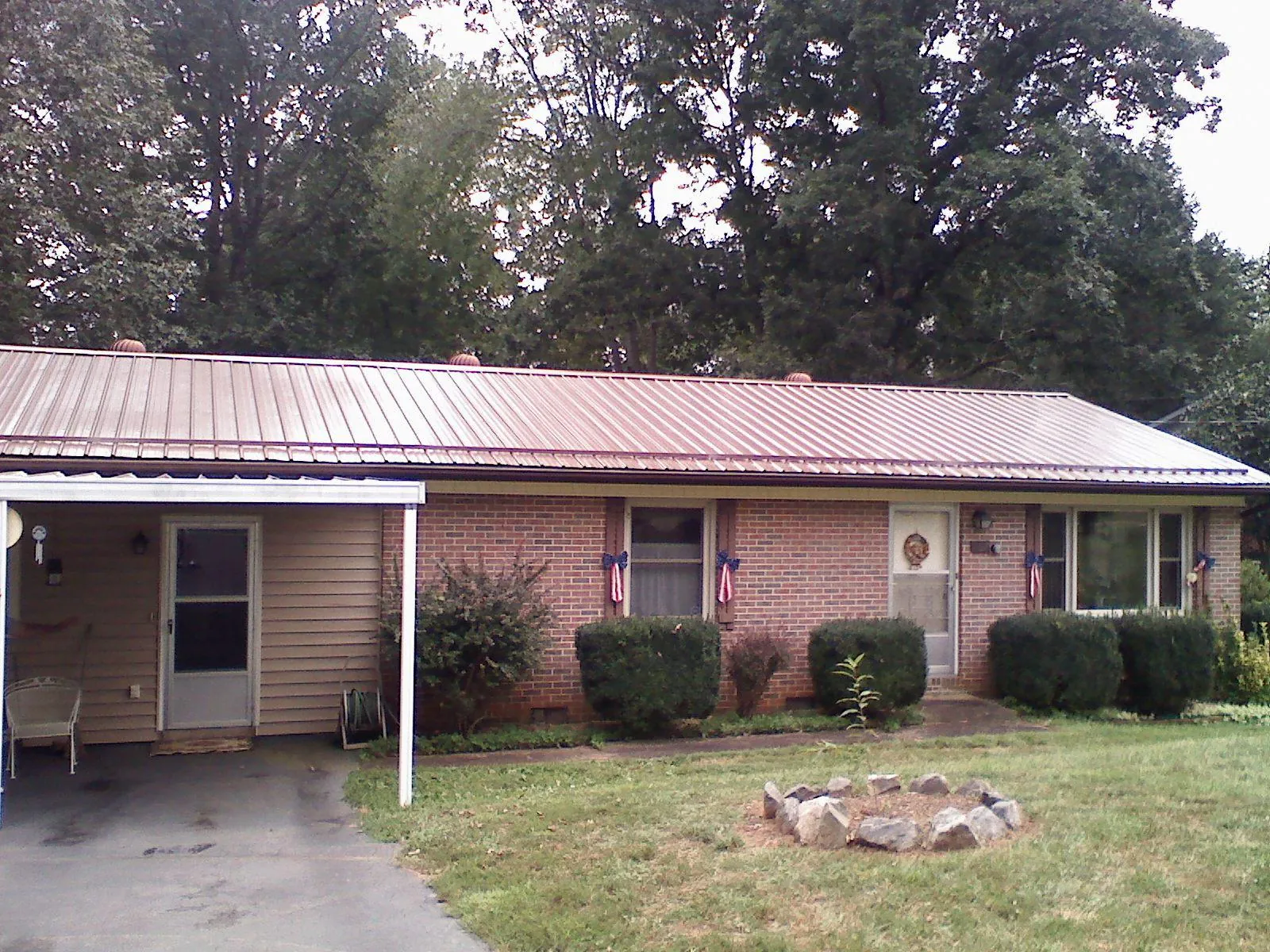 Bronze metal roof and carport on a brick ranch home — Roof Repair work by our crew in Issaquah